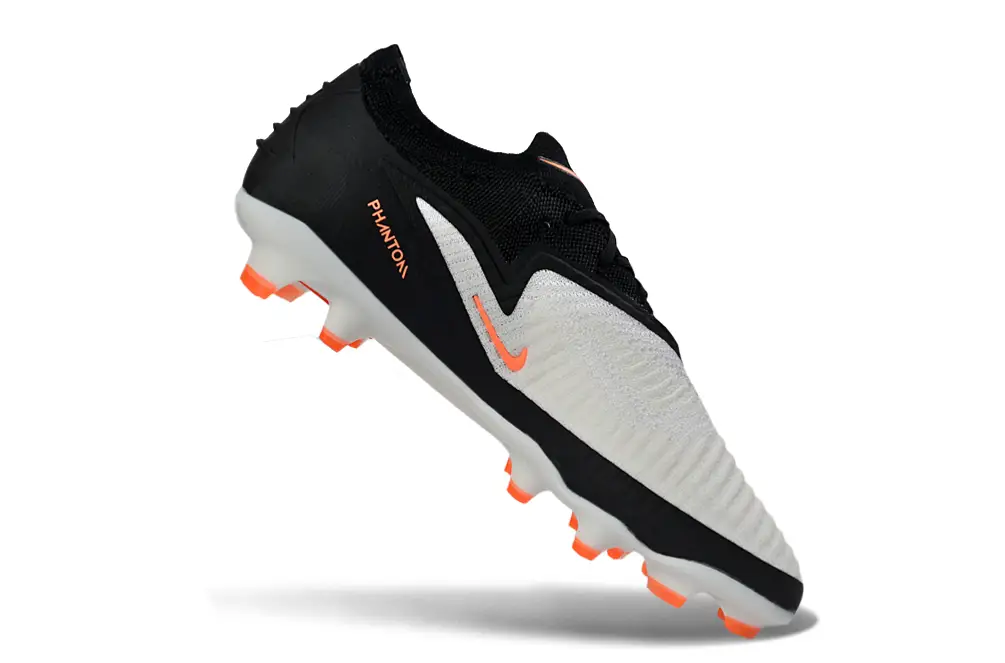 Nike Phantom 6 Elite FG football boot in action on a grass football field