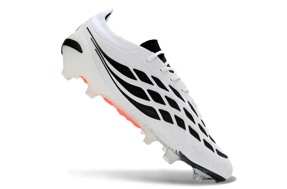 Adidas Predator 26 Elite FG football boot in action on a green grass field